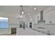 Modern kitchen with white cabinets, stainless steel appliances, and a large island at 485 Adams View Ln, Auburndale, FL 33823