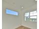 Bright bedroom with hardwood floors and large windows offering scenic views at 485 Adams View Ln, Auburndale, FL 33823