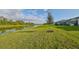 Peaceful backyard with a lake view, lush green grass at 485 Adams View Ln, Auburndale, FL 33823