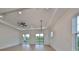 Spacious living room with hardwood floors, high ceilings, and sliding glass doors at 485 Adams View Ln, Auburndale, FL 33823