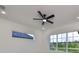 Bright bedroom with wood floors, ceiling fan, and large windows offering natural light at 485 Adams View Ln, Auburndale, FL 33823