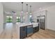 Modern kitchen with a large island, stainless steel appliances, and white cabinetry at 485 Adams View Ln, Auburndale, FL 33823