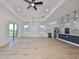 Open living room features hardwood floors, recessed lighting, and a modern chandelier at 485 Adams View Ln, Auburndale, FL 33823