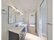 Modern bathroom with double vanity, large mirror and a walk-in shower at 485 Adams View Ln, Auburndale, FL 33823