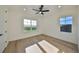 Bright bedroom with wood floors, ceiling fan and lake view at 485 Adams View Ln, Auburndale, FL 33823