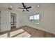 Spacious bedroom featuring hardwood floors, multiple windows and access to hallway at 485 Adams View Ln, Auburndale, FL 33823