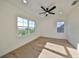Bright bedroom with hardwood floors, large windows, and ceiling fan at 485 Adams View Ln, Auburndale, FL 33823