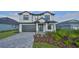 Two-story home with a gray brick driveway at 485 Adams View Ln, Auburndale, FL 33823