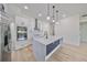 Sleek kitchen with white cabinetry, quartz countertops and stainless steel appliances at 485 Adams View Ln, Auburndale, FL 33823