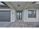 Modern home exterior featuring a stylish front door and paved walkway at 485 Adams View Ln, Auburndale, FL 33823