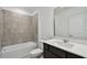 Bathroom boasts a vanity with white countertop and grey tile shower at 468 Waterford Dr, Lake Alfred, FL 33850