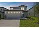 Two-story home with a two-car garage and well-manicured lawn at 468 Waterford Dr, Lake Alfred, FL 33850