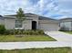 Single-story home with attached garage and landscaped front yard at 6945 Church Lake St, Groveland, FL 34736
