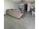 Spacious living area featuring a comfortable sectional sofa and grey tile floors at 6945 Church Lake St, Groveland, FL 34736
