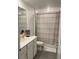 Clean bathroom with tub/shower combo, vanity, and neutral tones at 6945 Church Lake St, Groveland, FL 34736