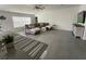Bright living room with tile floors, sectional sofa, and large TV at 6945 Church Lake St, Groveland, FL 34736