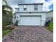 Two-story house with white siding and a two-car garage at 1564 Eucalyptus Way, Davenport, FL 33837