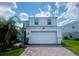 Two-story house with a white exterior and two-car garage at 1564 Eucalyptus Way, Davenport, FL 33837
