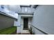 Two-story home with a dark green front door and landscaping at 1564 Eucalyptus Way, Davenport, FL 33837