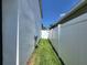 Side yard with grassy area and white vinyl fence at 1564 Eucalyptus Way, Davenport, FL 33837