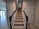 Elegant staircase with black and white railings at 1564 Eucalyptus Way, Davenport, FL 33837