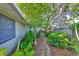 Landscaped backyard with mature trees and stone pathway at 220 Coleman E Dr, Winter Haven, FL 33884