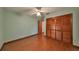 Bedroom with wood flooring, closet, and ceiling fan at 220 Coleman E Dr, Winter Haven, FL 33884