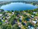 Aerial view showing a lakefront home with a large yard at 220 Coleman E Dr, Winter Haven, FL 33884
