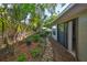 Landscaped backyard with stone pathway and mature trees at 220 Coleman E Dr, Winter Haven, FL 33884