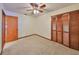 Bedroom with wood closet doors and carpet flooring at 220 Coleman E Dr, Winter Haven, FL 33884