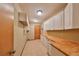Laundry room with wood cabinets and butcher block countertops at 220 Coleman E Dr, Winter Haven, FL 33884