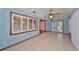 Bright sunroom with tile floors, built-in seating, and access to the outdoors at 220 Coleman E Dr, Winter Haven, FL 33884