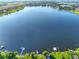 Aerial view of a serene lake with houses along the shoreline at 220 Coleman E Dr, Winter Haven, FL 33884