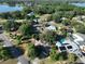 Aerial view showcasing a house near the lake, with a pool and solar panels at 220 Coleman E Dr, Winter Haven, FL 33884