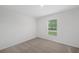 Spacious bedroom with neutral carpeting and window at 414 Caribbean Ct, Poinciana, FL 34759
