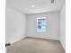 Spacious bedroom with neutral carpeting and a window at 4270 Sw 143Rd Lane Rd, Ocala, FL 34473