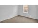 Simple bedroom with neutral carpeting and a window at 4270 Sw 143Rd Lane Rd, Ocala, FL 34473