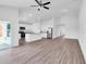 Open concept living room and kitchen with high ceilings and vinyl plank flooring at 4270 Sw 143Rd Lane Rd, Ocala, FL 34473
