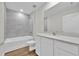 Clean bathroom with white cabinets, a bathtub, and a shower at 4270 Sw 143Rd Lane Rd, Ocala, FL 34473