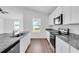 Modern kitchen with granite countertops, stainless steel appliances, and white cabinets at 4270 Sw 143Rd Lane Rd, Ocala, FL 34473
