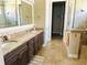 Elegant bathroom with double vanity, granite countertops, and large mirror at 7771 Lake James Blvd, Lakeland, FL 33810