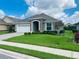 One-story home with a two-car garage and landscaped lawn at 7771 Lake James Blvd, Lakeland, FL 33810