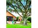Outdoor space featuring a stone fireplace and lush landscaping at 5446 Pebble Beach Dr, Lakeland, FL 33812