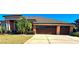 Beautiful one-story home with three car garage and lush landscaping at 5446 Pebble Beach Dr, Lakeland, FL 33812