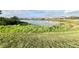 Calm lake view with a row of houses and lush vegetation at 210 Kenny Blvd, Haines City, FL 33844