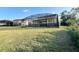 Large backyard with a screened pool and patio at 210 Kenny Blvd, Haines City, FL 33844