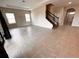 Bright living room with tile floors and a staircase leading upstairs at 210 Kenny Blvd, Haines City, FL 33844