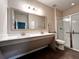Bathroom boasts double sinks, a large mirror, and a walk-in shower at 210 Kenny Blvd, Haines City, FL 33844