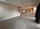 Open living room features tile floors, a kitchen with island, and a staircase at 210 Kenny Blvd, Haines City, FL 33844