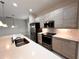 Modern kitchen with stainless steel appliances and white countertops at 210 Kenny Blvd, Haines City, FL 33844